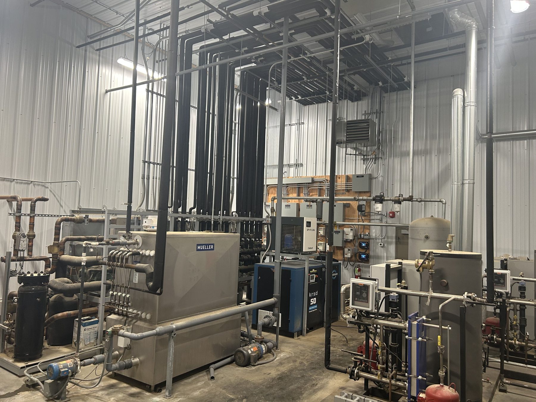 Refrigeration equipment room with compressors and piping